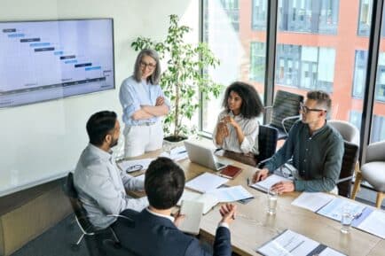 Stock image: Men and women in meeting space