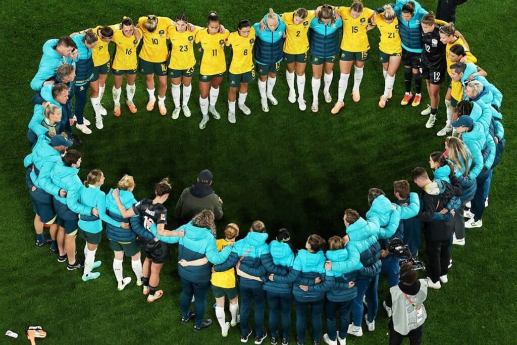 Matildas huddle in heart-shape formation after losing to England in the semi-final of the FIFA Women's World Cup.