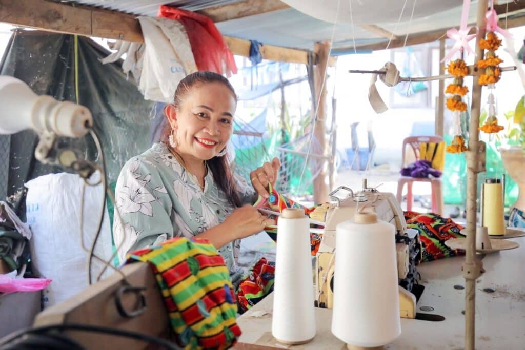 Thai woman Ning sews as part of her small business, funded by Lendwithcare.
