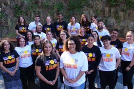 Allira Davis and Bridget Cama standing with members of the Uluru Youth Dialogues. Credit: Supplied